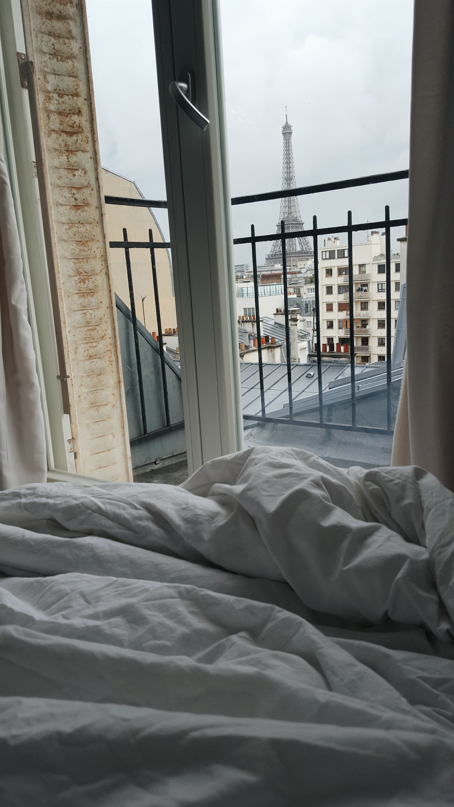 View of the Eiffel Tower from a Paris Airbnb bed