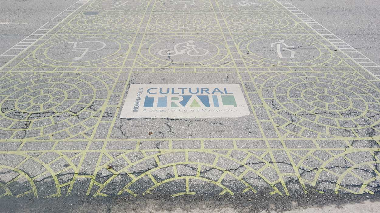 A crosswalk that reads "Indianapolis Cultural Trail"
