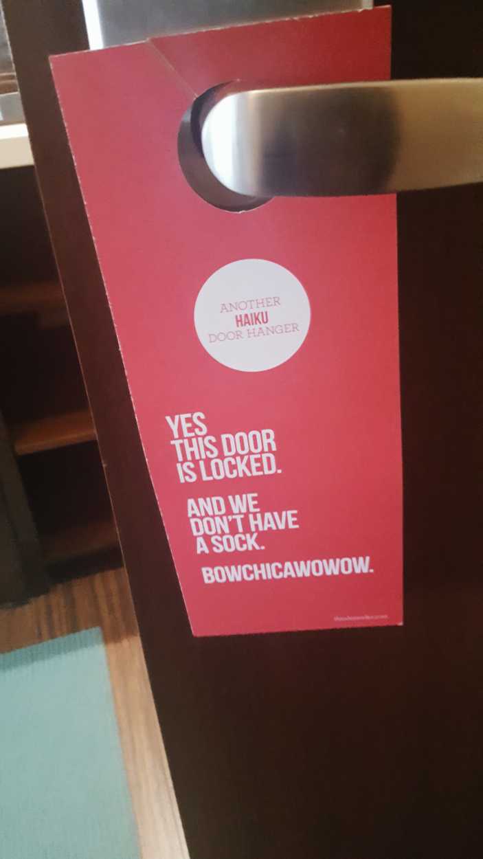 A cheeky doorhanger that reads "Yes this door is locked. And we don't have a sock. Bowchicawowow"