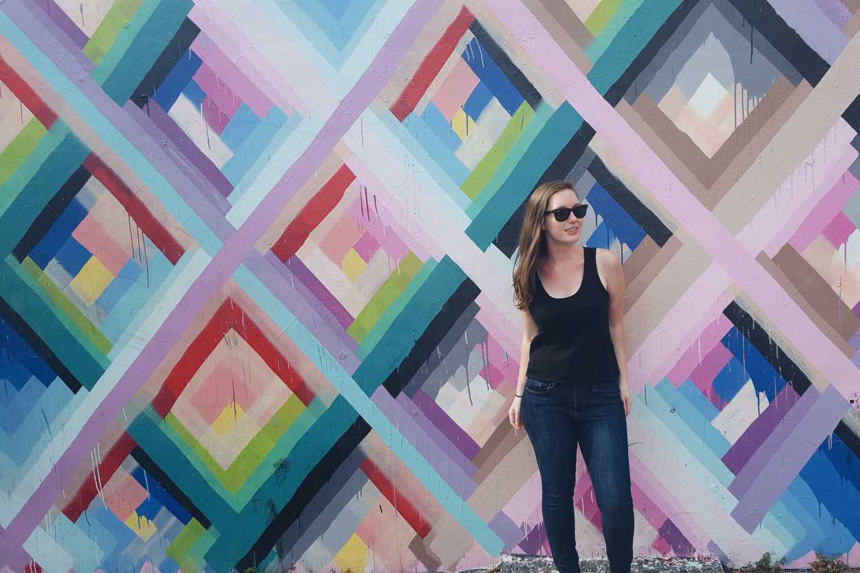 Alyssa stands in front of a mural at Wynwood Walls
