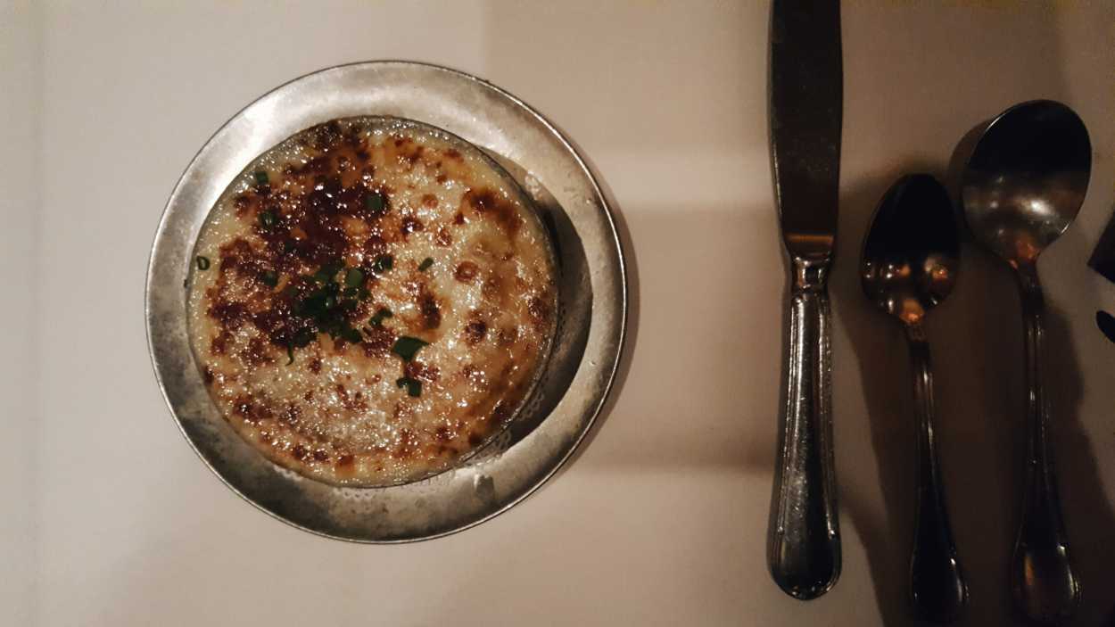 A bowl of French Onion Soup on a table