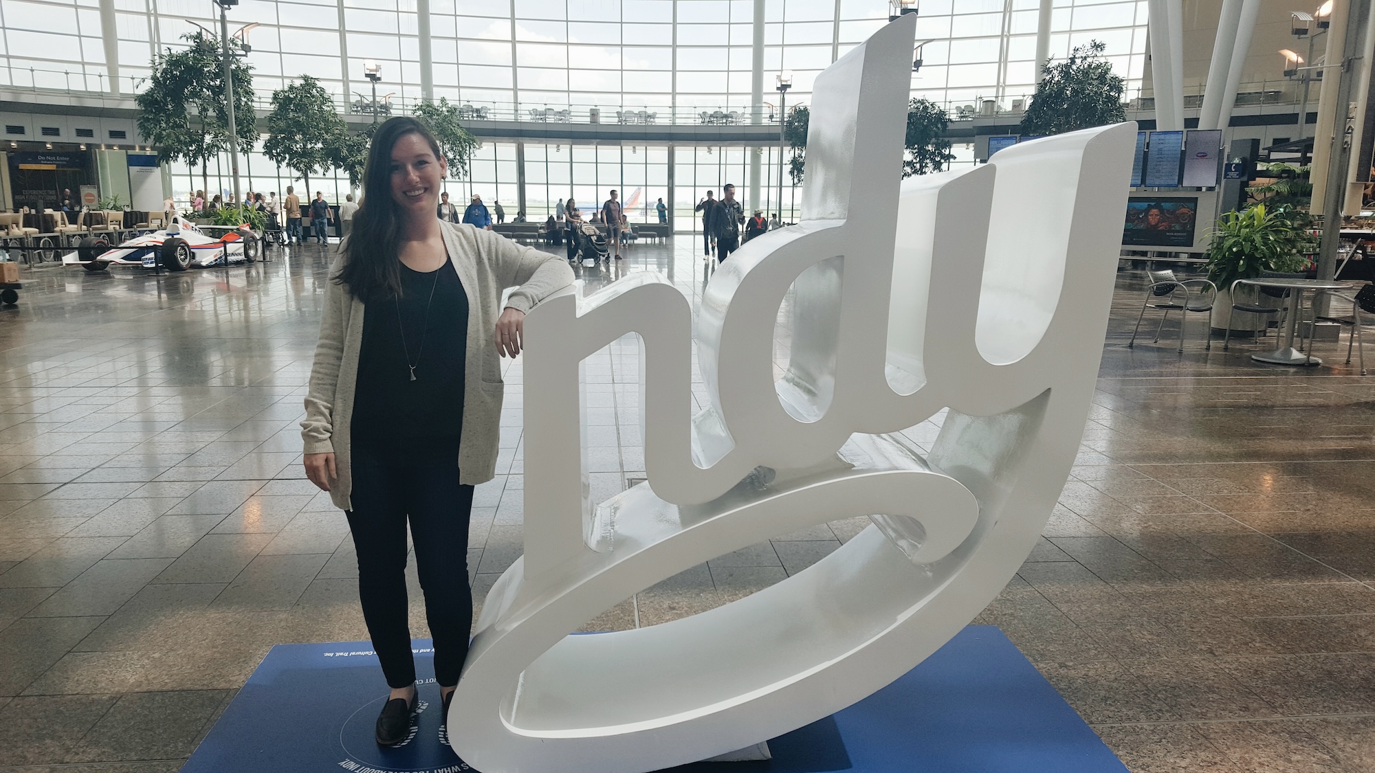 Alyssa stands next to a sign that says "ndy" and she is the I