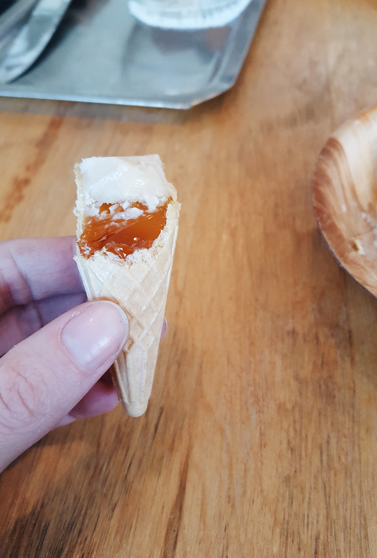 Alyssa holds a sugar cone filled with maple syrup and taffy