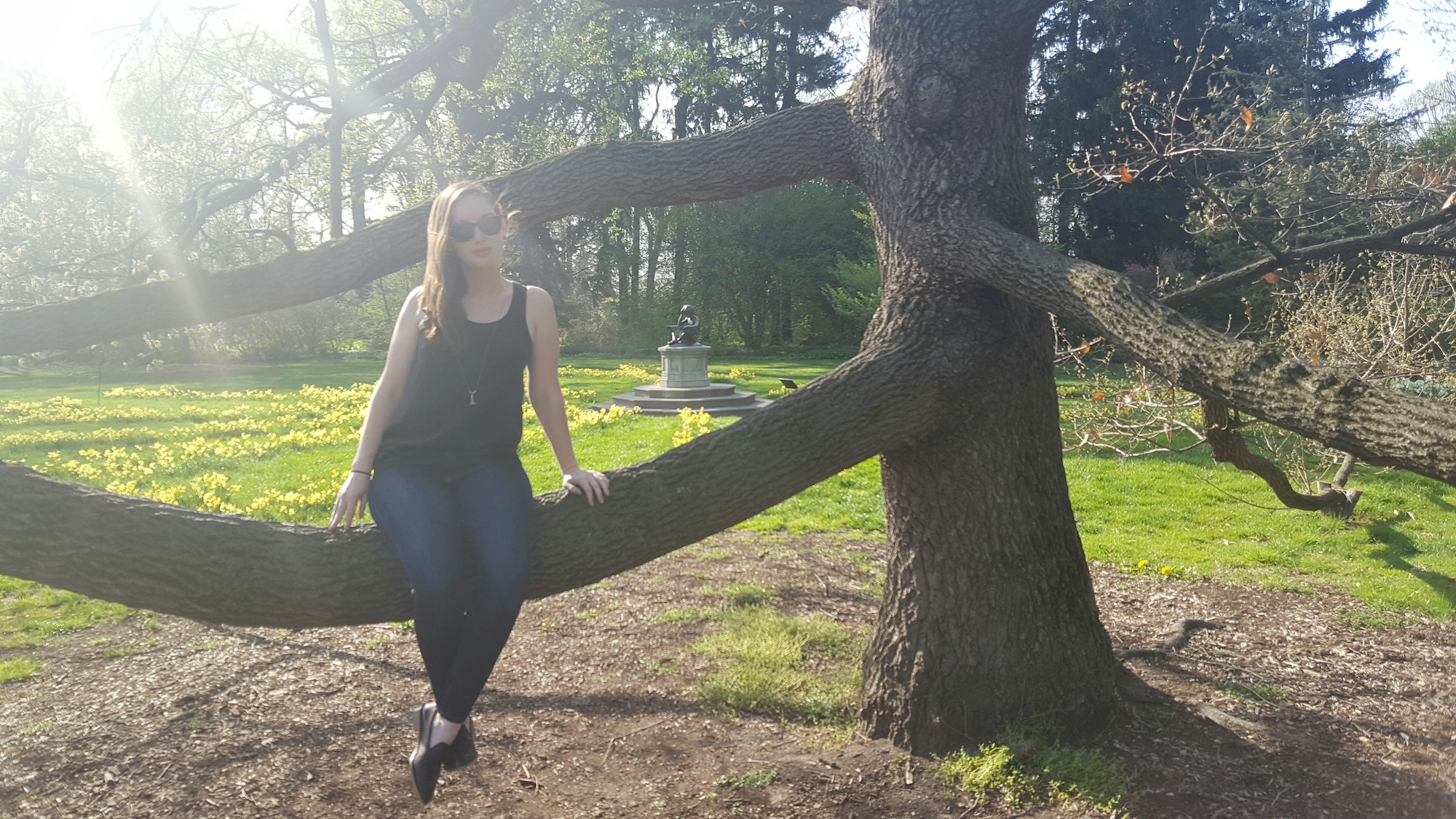 Alyssa sits in a tree at the Indianapolis Museum of Art