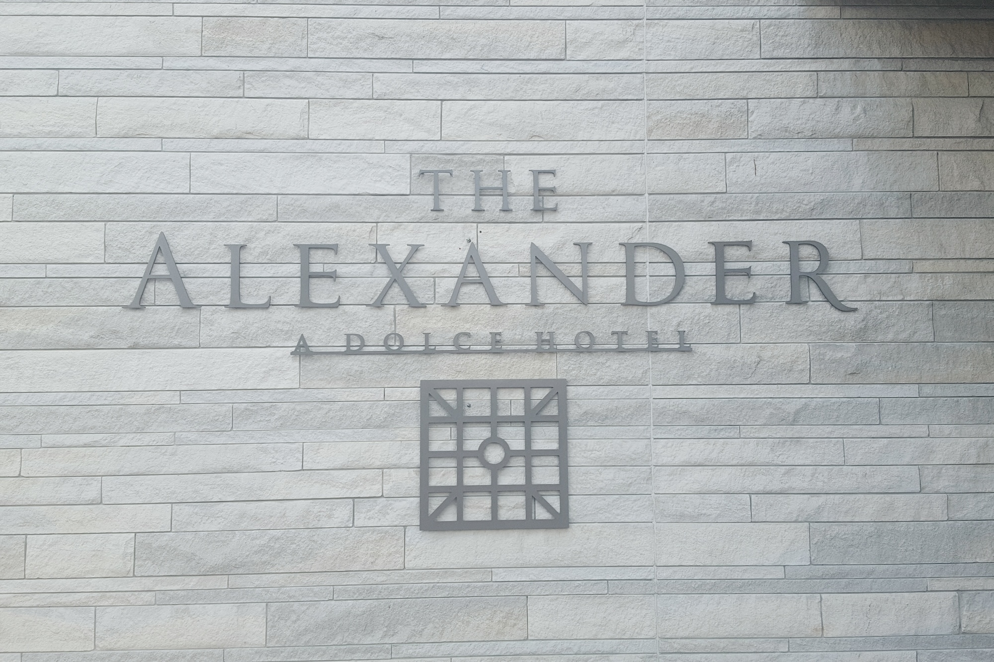 Sign with a logo for The Alexander Hotel in Indianapolis