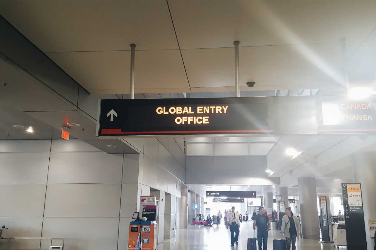 A sign pointing to the Global Entry office at the airport in Miami