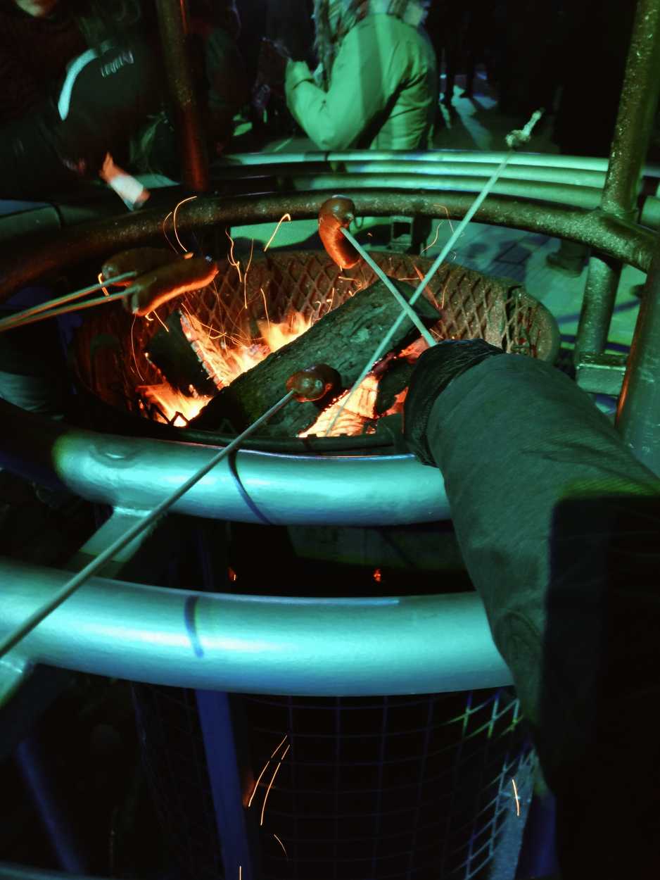 Roasting hot dogs over a firepit