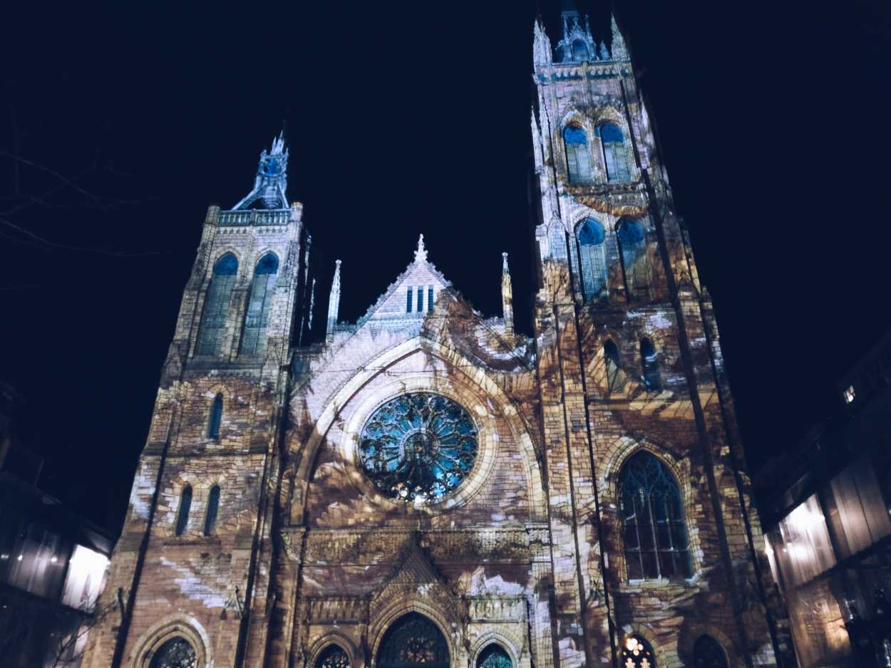 An art scene projected on a cathedral wall