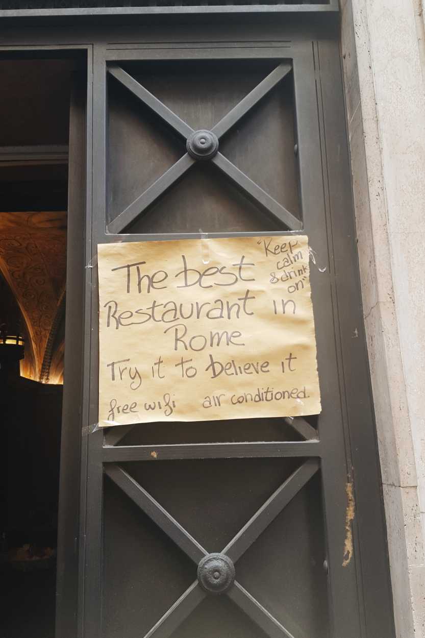 A sign that reads "The Best Restaurant in Rome"