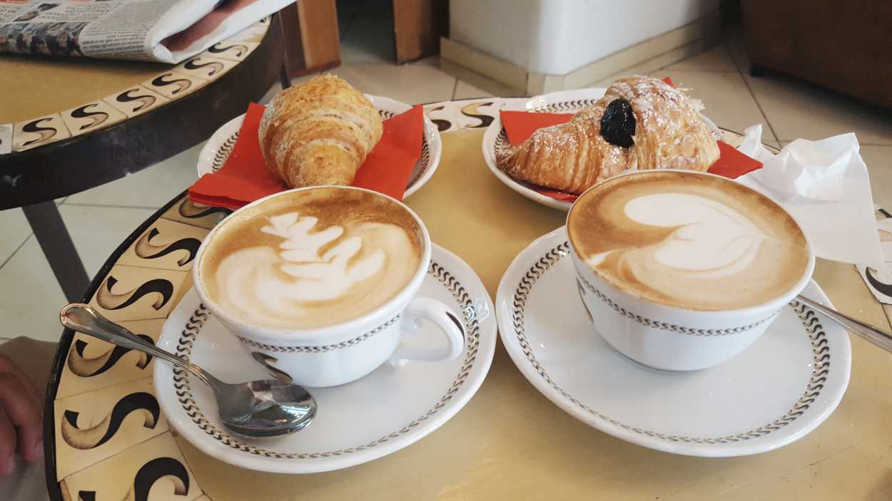 Cappuccinos and croissants on a table in Italy