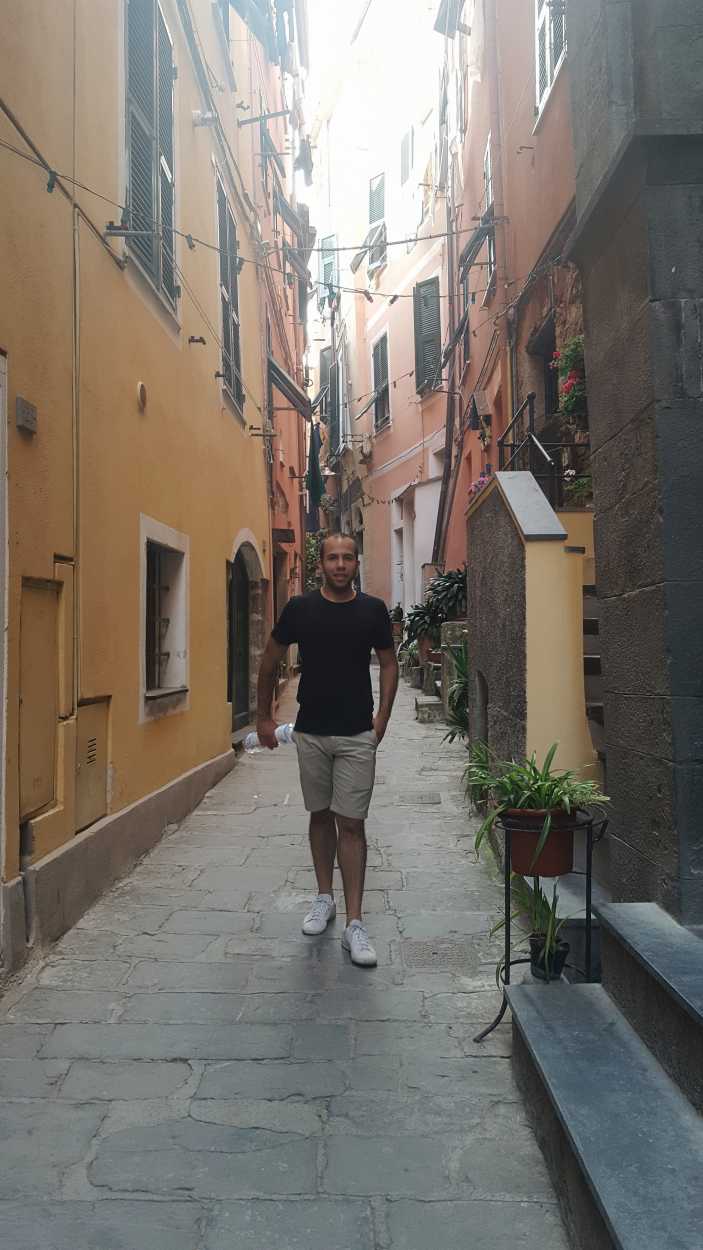 Michael walks in an alley in Vernazza