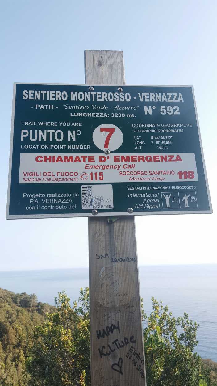 A sign giving emergency contact information