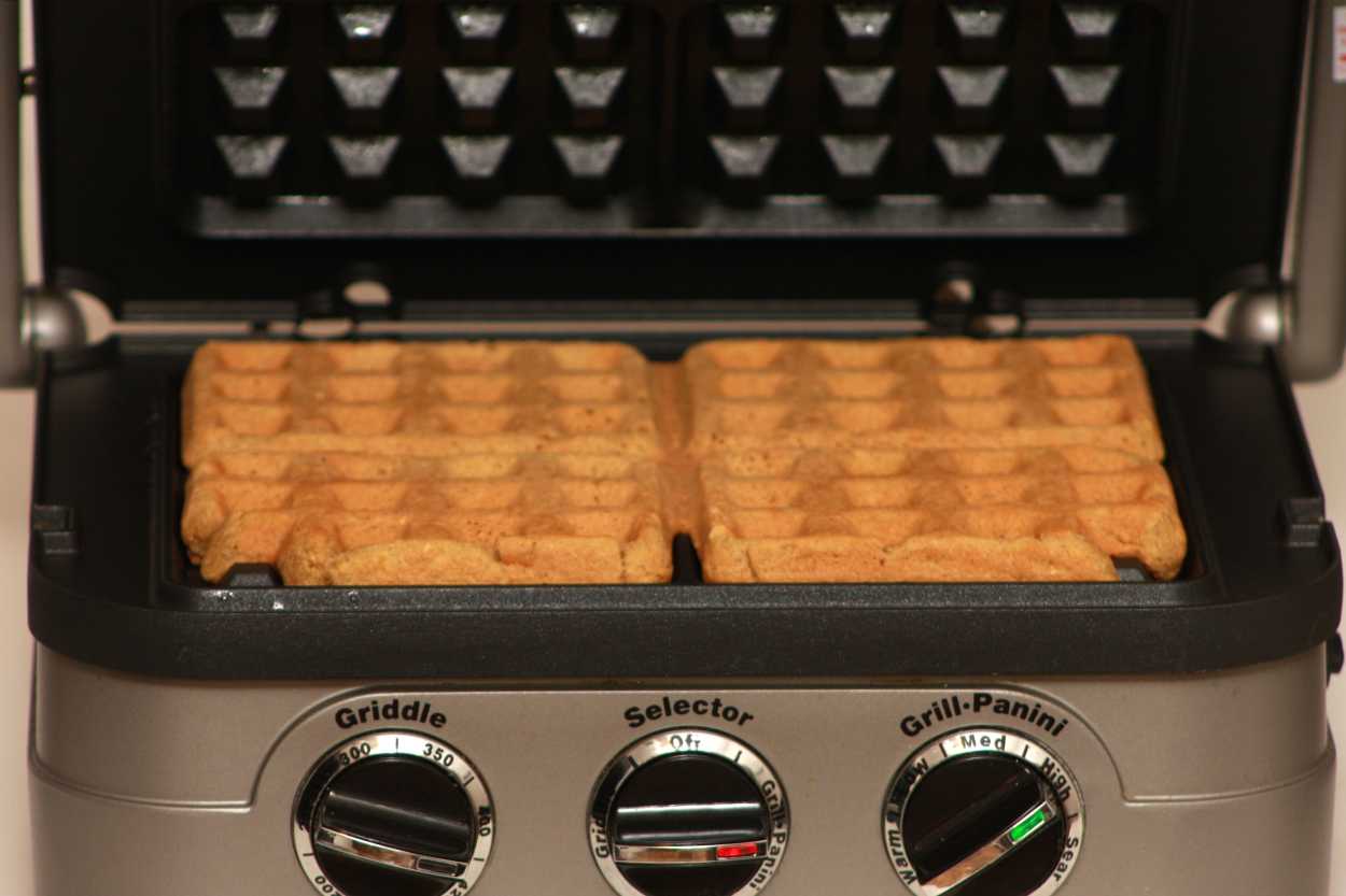 A waffle iron with four waffles