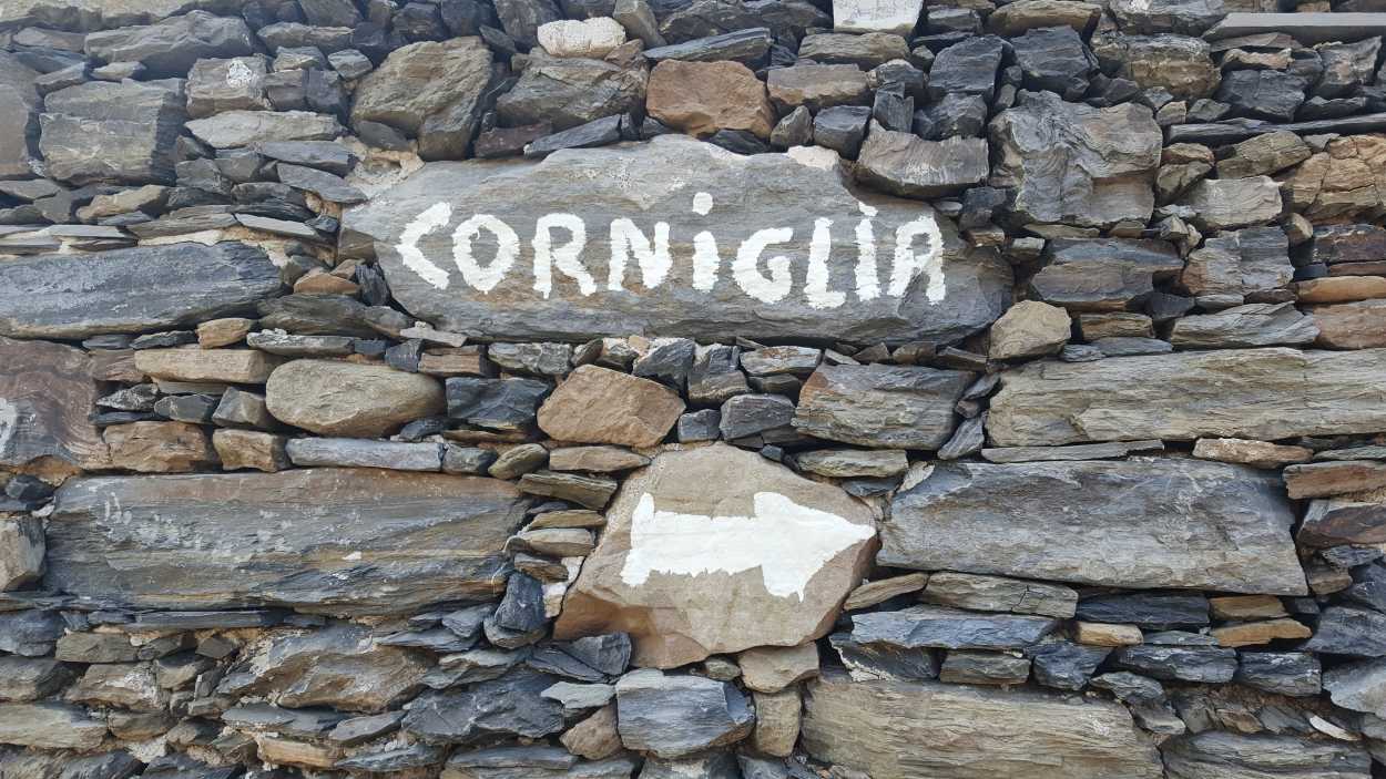 Corniglia is painted on a stone wall