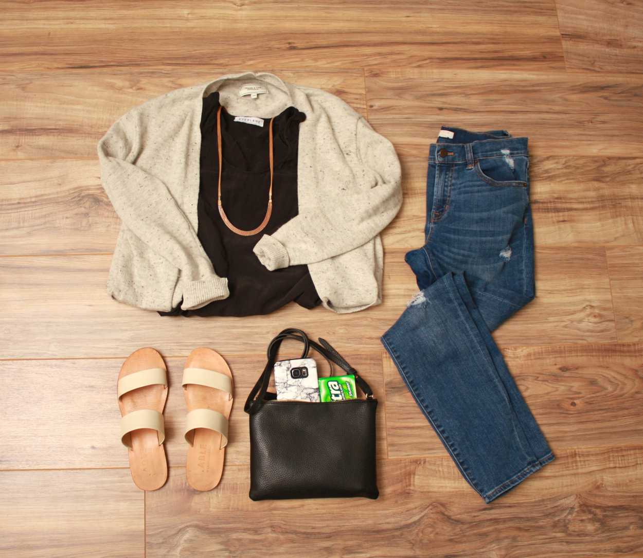 Nashville Packing List Flat lay: Black tank, blue jeans, white sandals