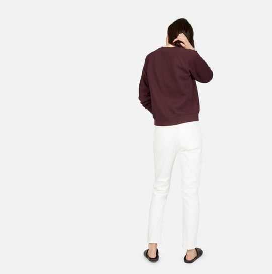 a photo of a woman in a burgundy sweatshirt, from behind
