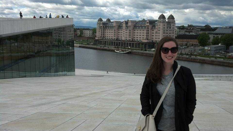 Alyssa stands in front of the Oslo Opera House