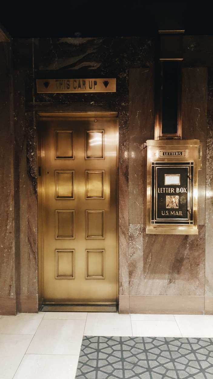 An old school elevator and letter box