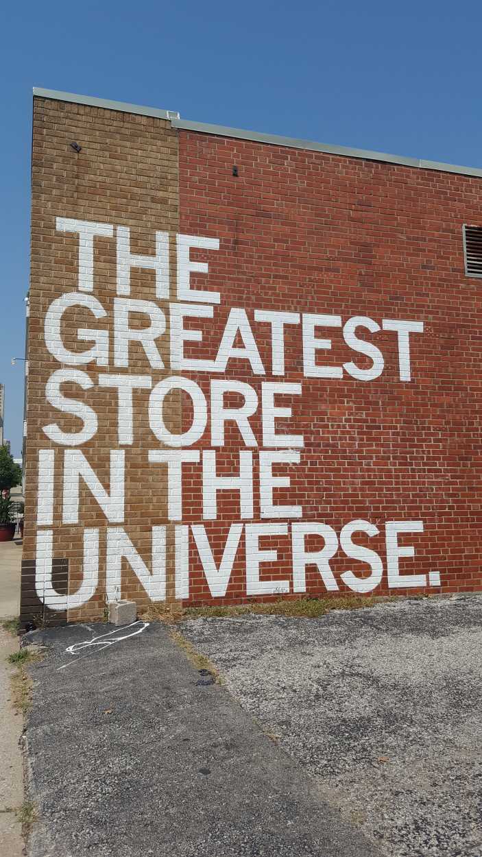 Outside of Raygun, with a mural that says "The Greatest Store in the Universe"