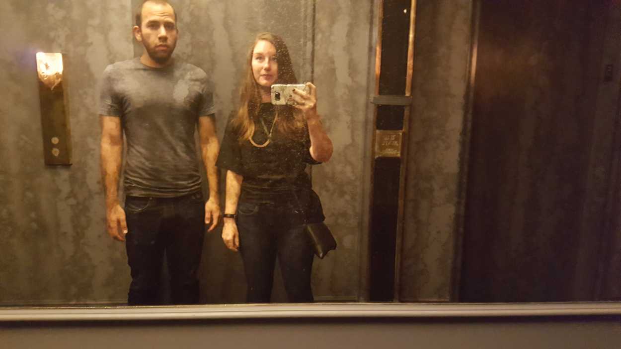 Alyssa and Michael take a photo in the hotel elevator reflection