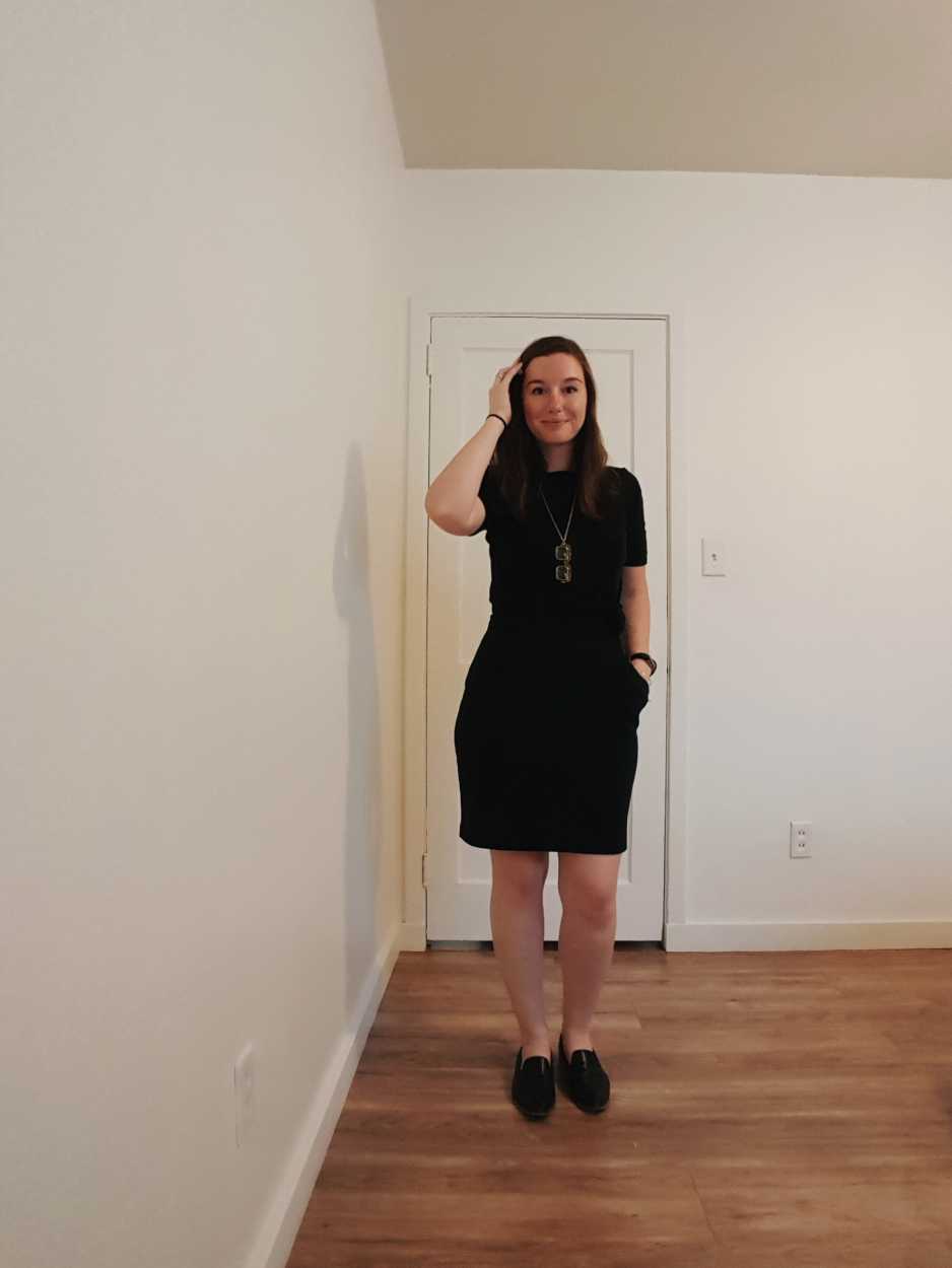 Alyssa wears a black dress with a black tee over it with black loafers in the evening