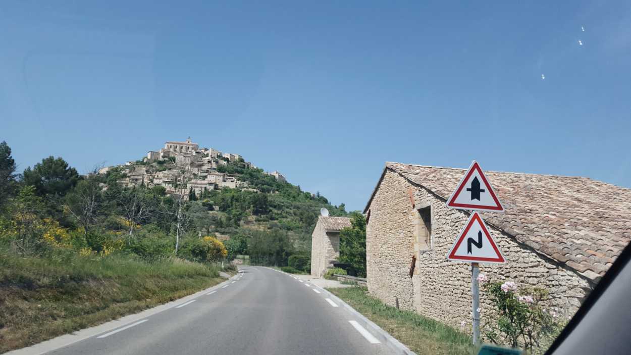 A road in Provence leading to a town on the hill