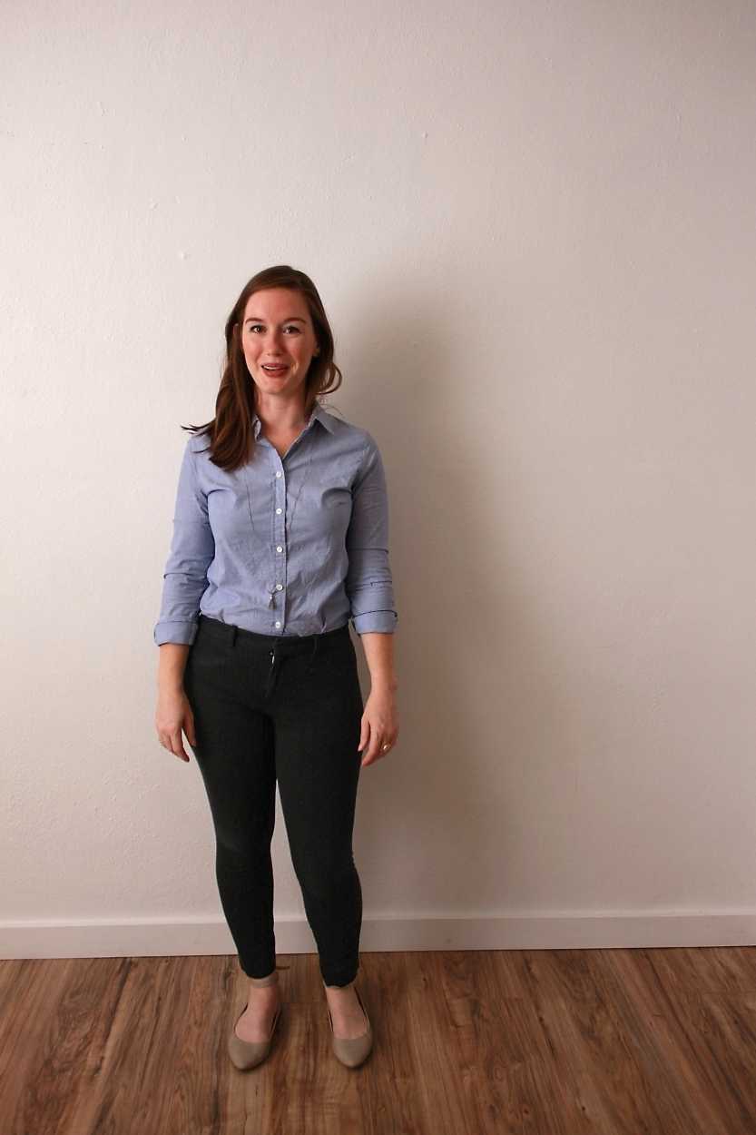 Alyssa wears a blue oxford shirt with black pants and beige flats