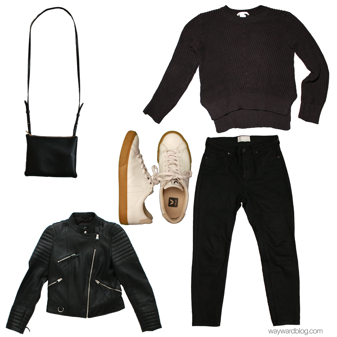 A black sweater, black jeans, leather jacket, and white sneakers