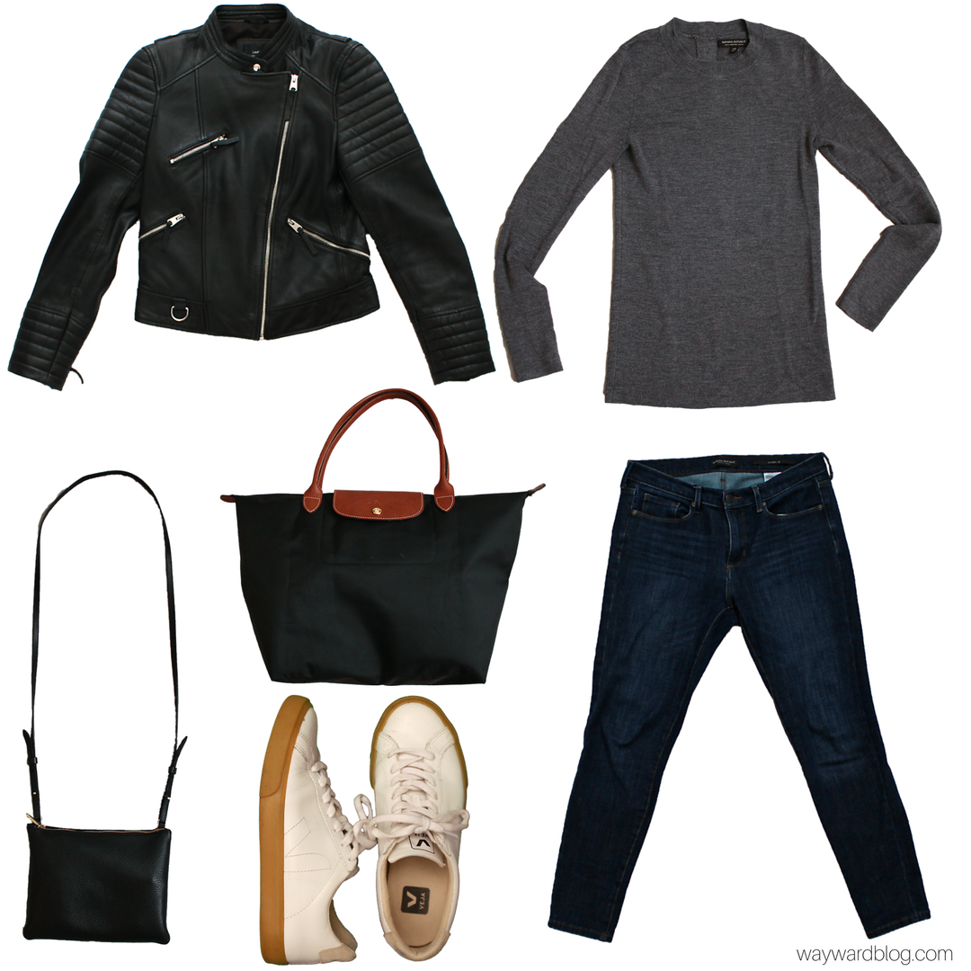 A grey sweater, blue jeans, white sneakers, two purses