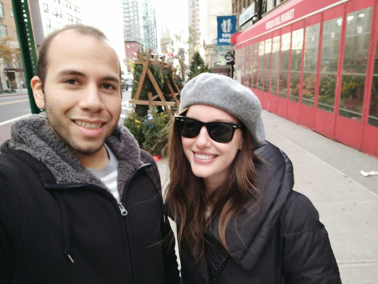 Alyssa and Michael take a selfie in front of a display of wreaths