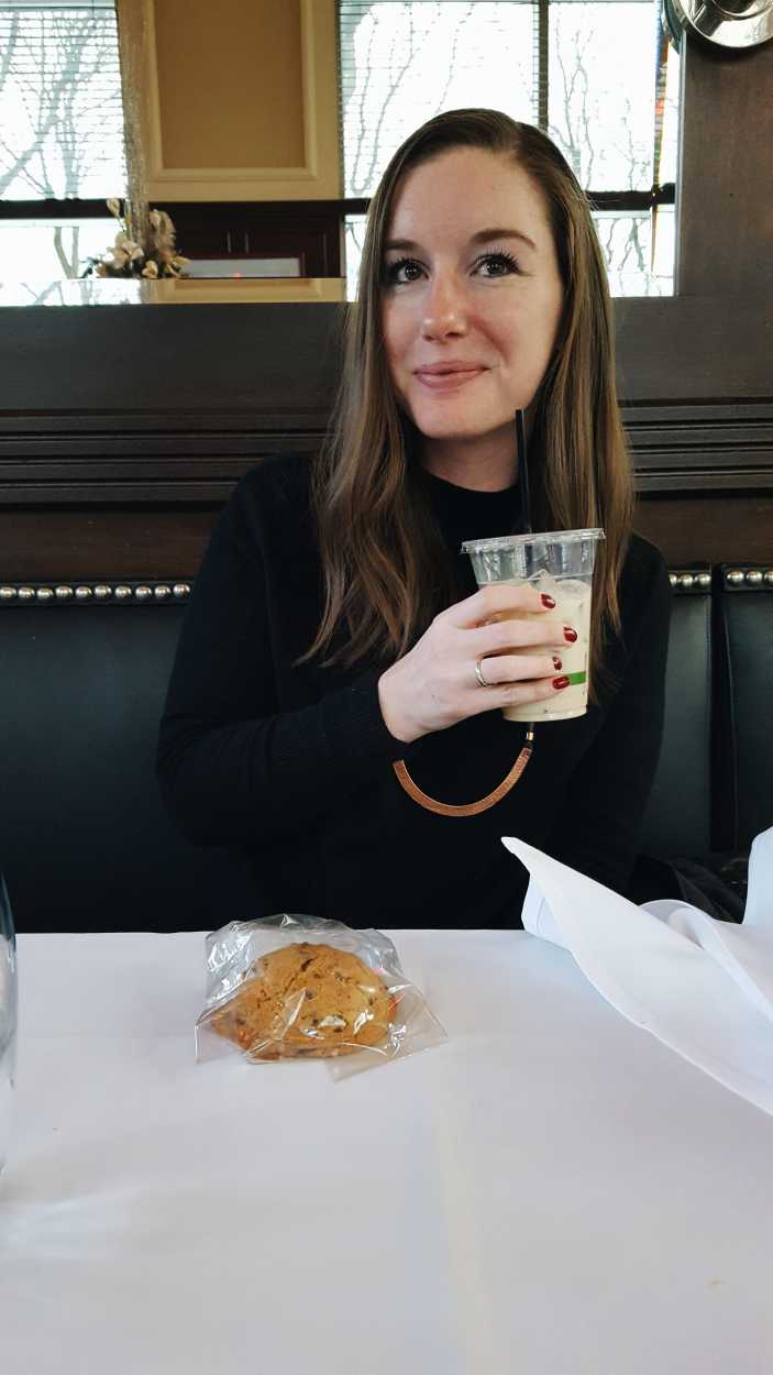 Alyssa holds a to-go cup of coffee milk, Rhode Island's state beverage