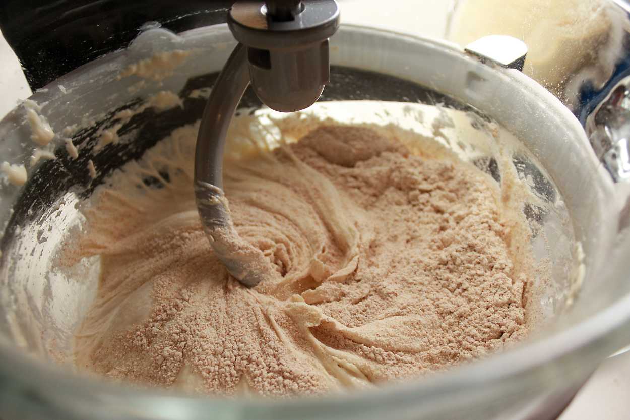 Adding flour to a bagel dough in a stand mixer