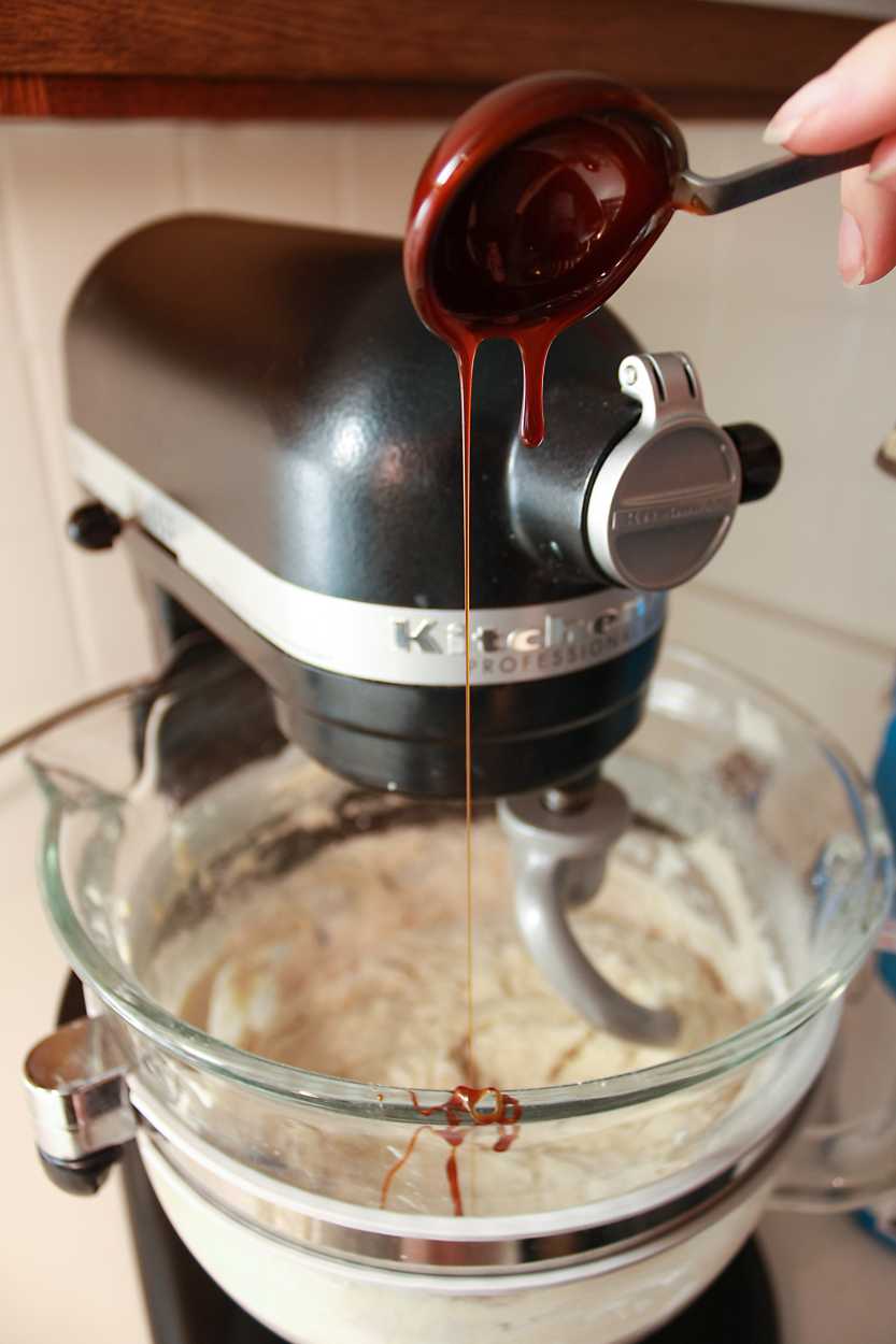 Adding malt syrup to the bagel dough in a stand mixer