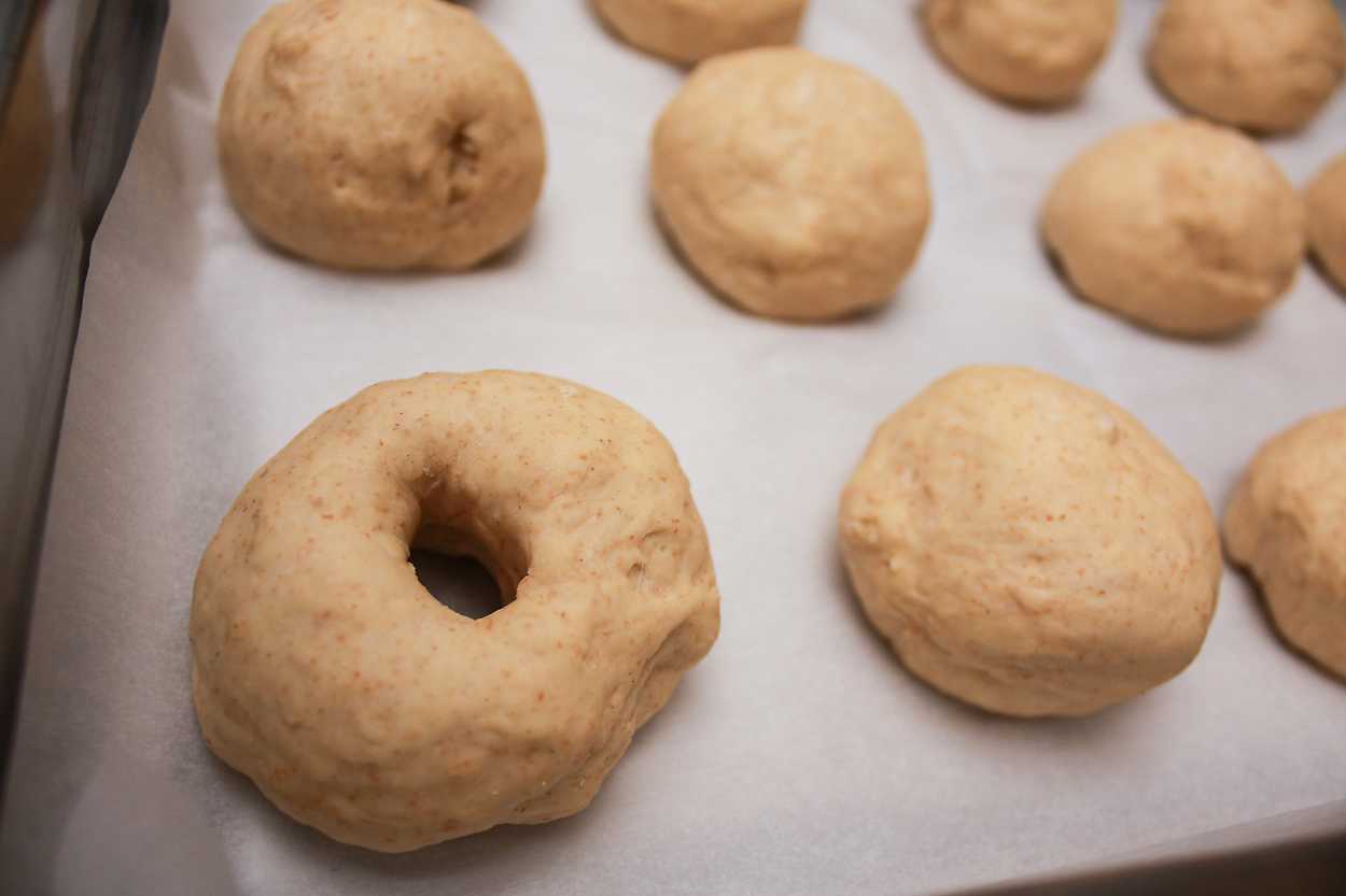 a tray of bagels waiting to be shaped