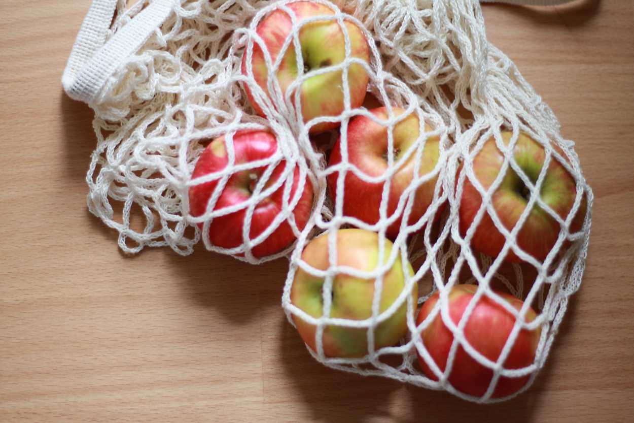 A mesh filet bag filled with apples