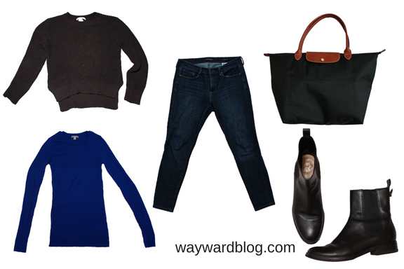 winter airplane travel outfit of sweaters, jeans, and boots