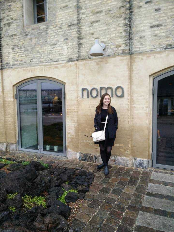 Alyssa stands in front of Noma in an old grainy photo