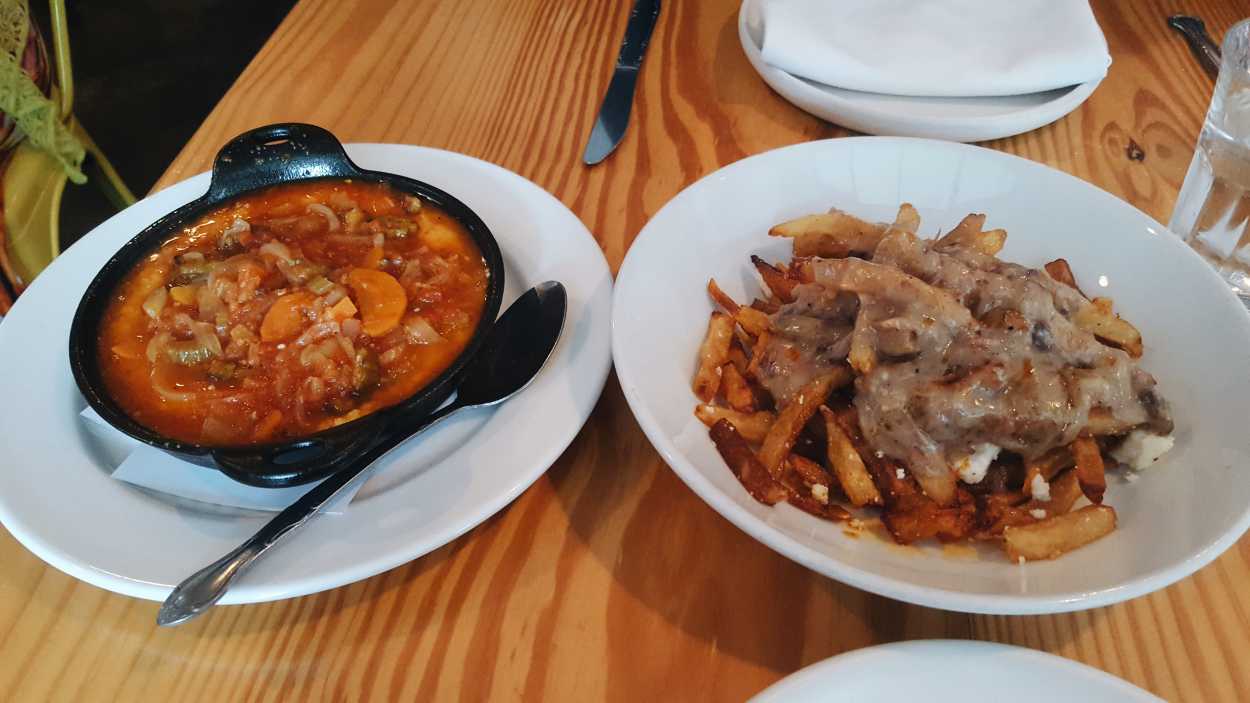 Two dishes from Hog & Hominy: polenta and poutine