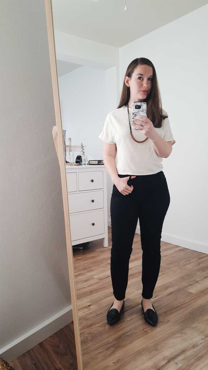 Alyssa wears a white raw silk tee with black pants and flats