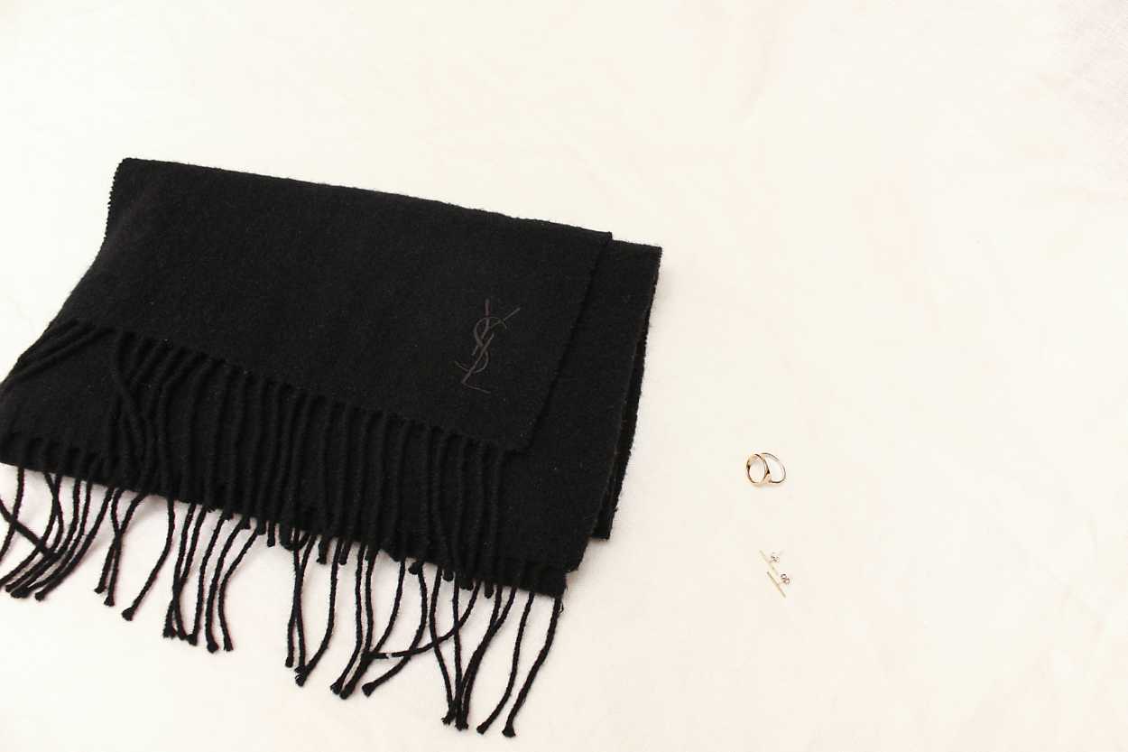 A black scarf with gold jewelry