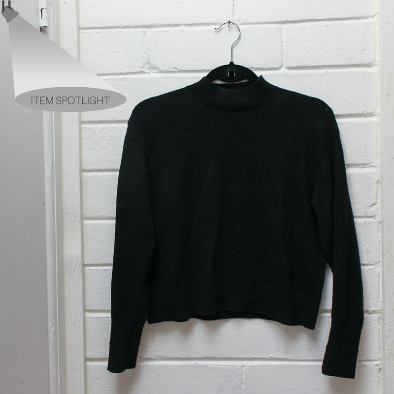 The everlane cashmere crop mockneck hangs on a peg