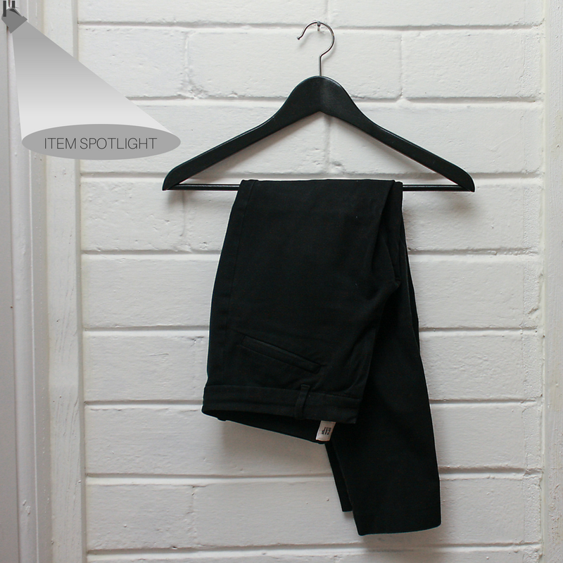 A pair of Gap ankle pants hang on a peg