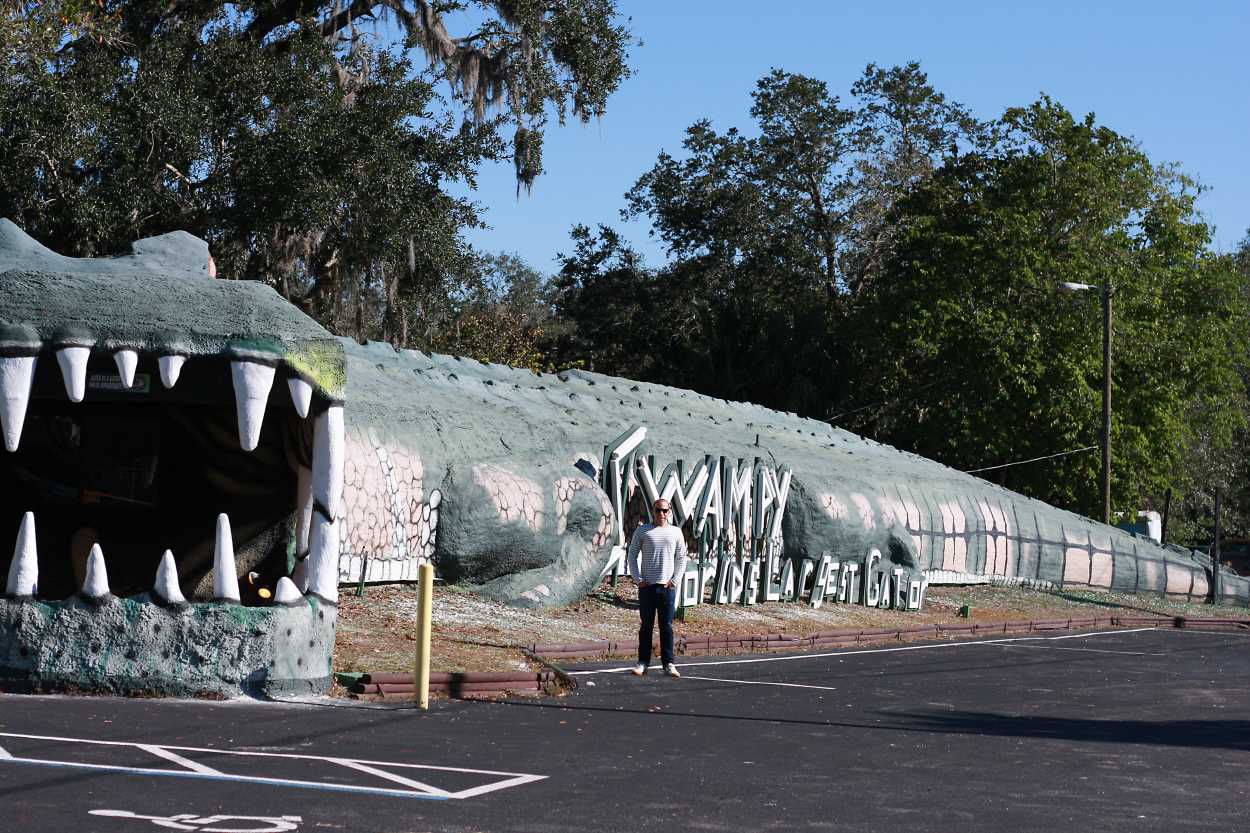 Michael stands in front of Swampy, the World's Largest Gator