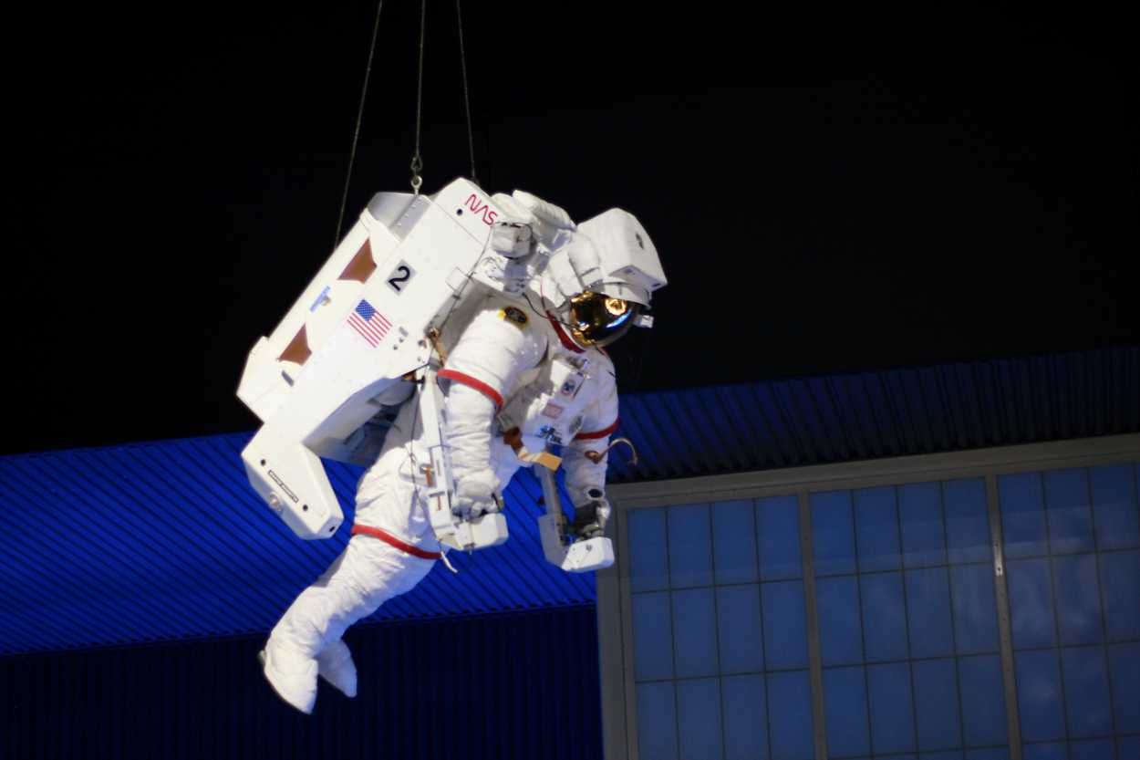 An astronaut model hanging from the ceiling at Kennedy Space Center
