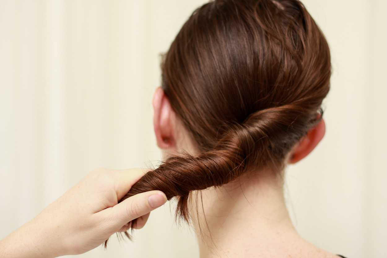 A close up image of hands twirling hair