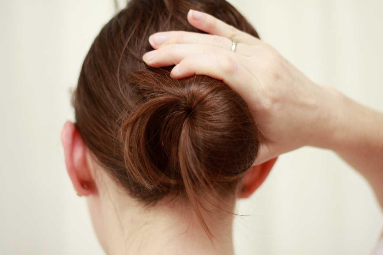 A close up image of hands holding a bun