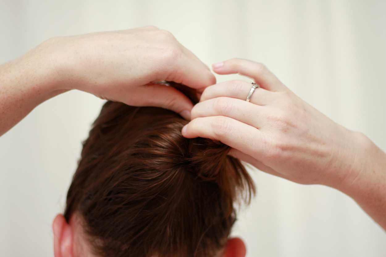 A close up image creating a hair updo