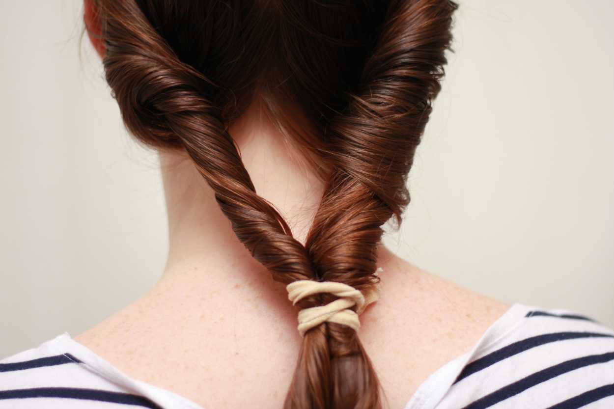 two twirls of hair in a rubber band