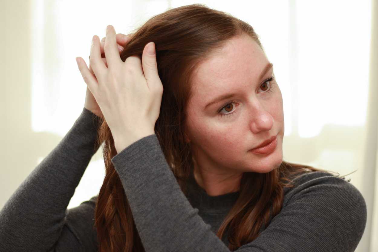 a woman adjusting her hair