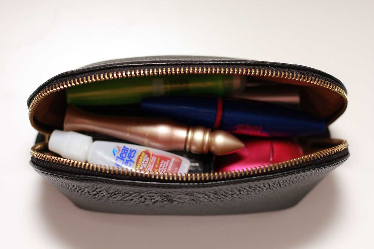 A close up of the inside of the makeup bag from the Leather Travel Case Set from Cuyana